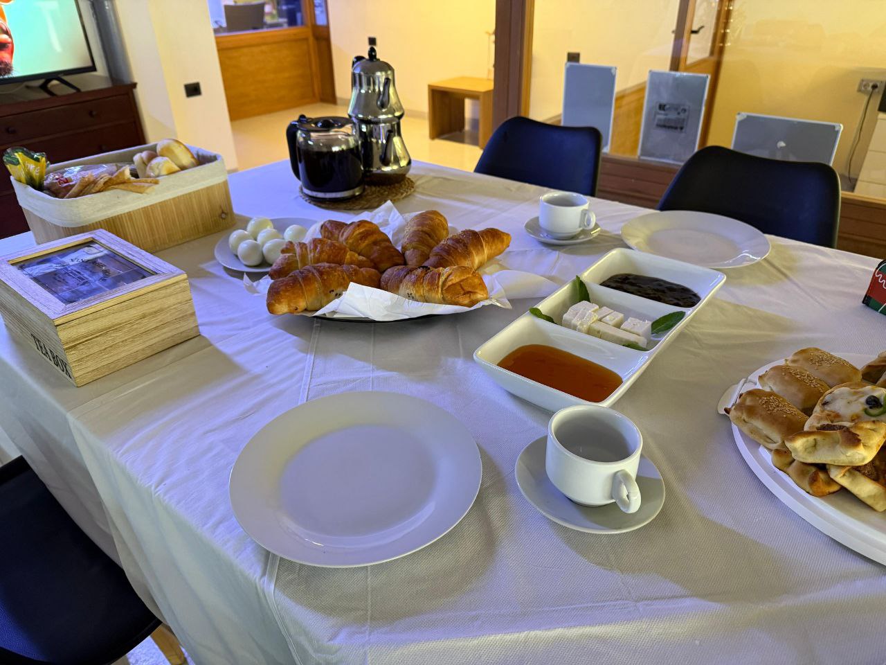 A SHADE breakfast table set with fresh bread, jams and coffee